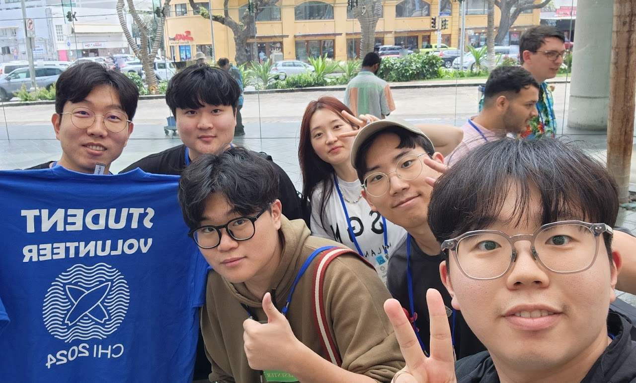 Outdoor group selfie with a CHI 2024 student volunteer shirt.