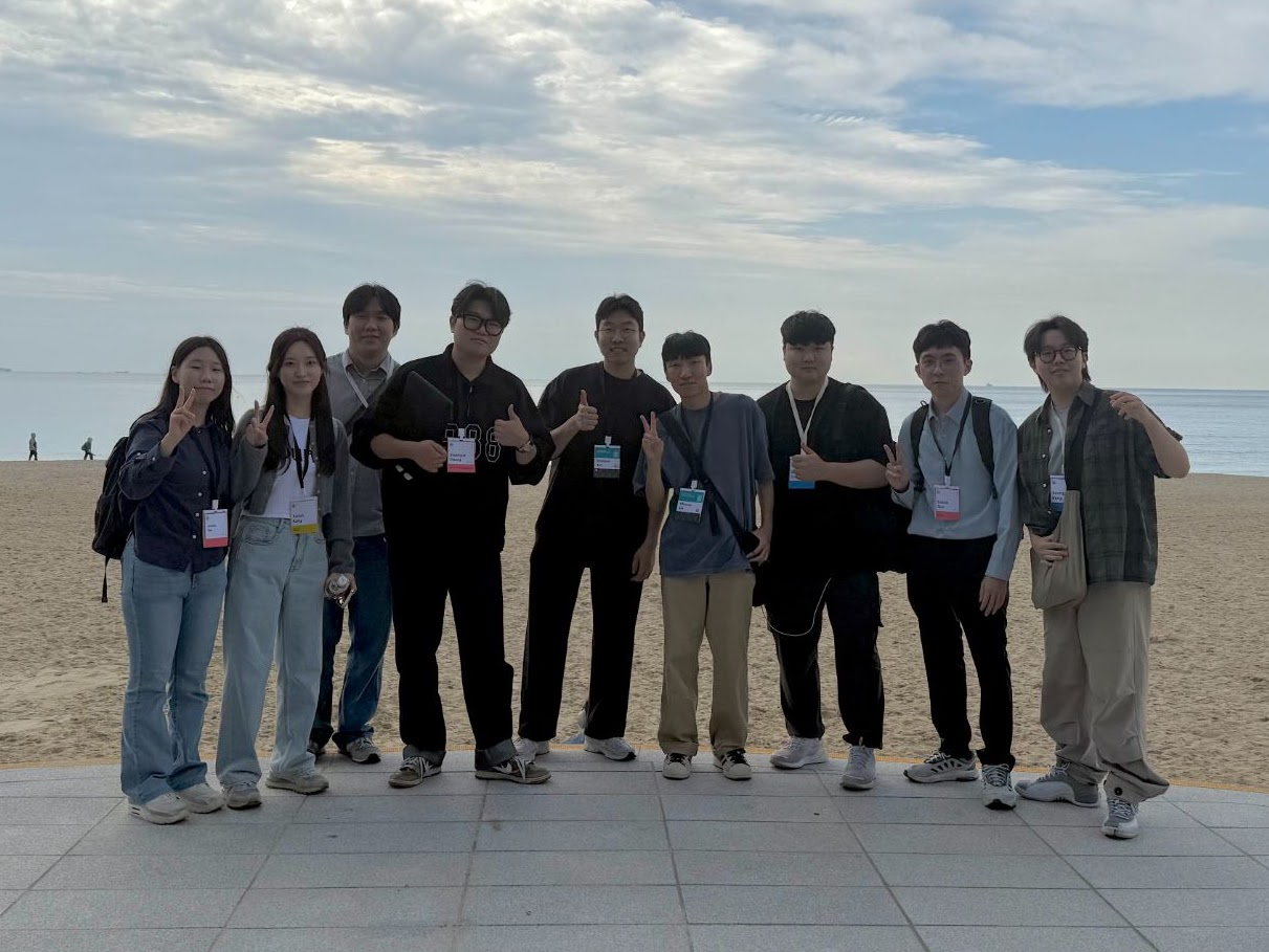 Group photo by the waterfront during the ISMAR 2025 conference trip.