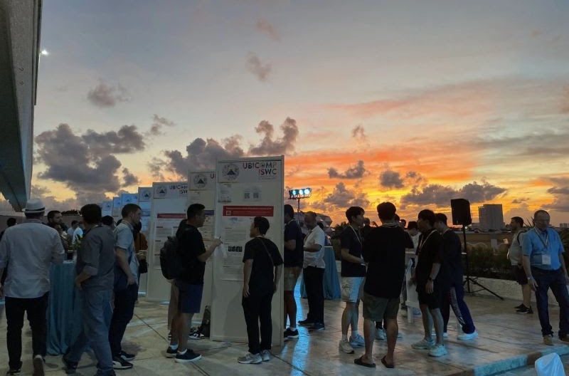 Outdoor poster session at sunset at UbiComp 2023.