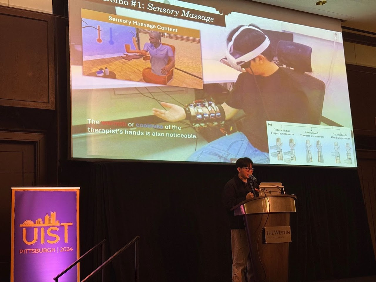 Conference presentation showing a sensory massage demonstration at UIST 2024.