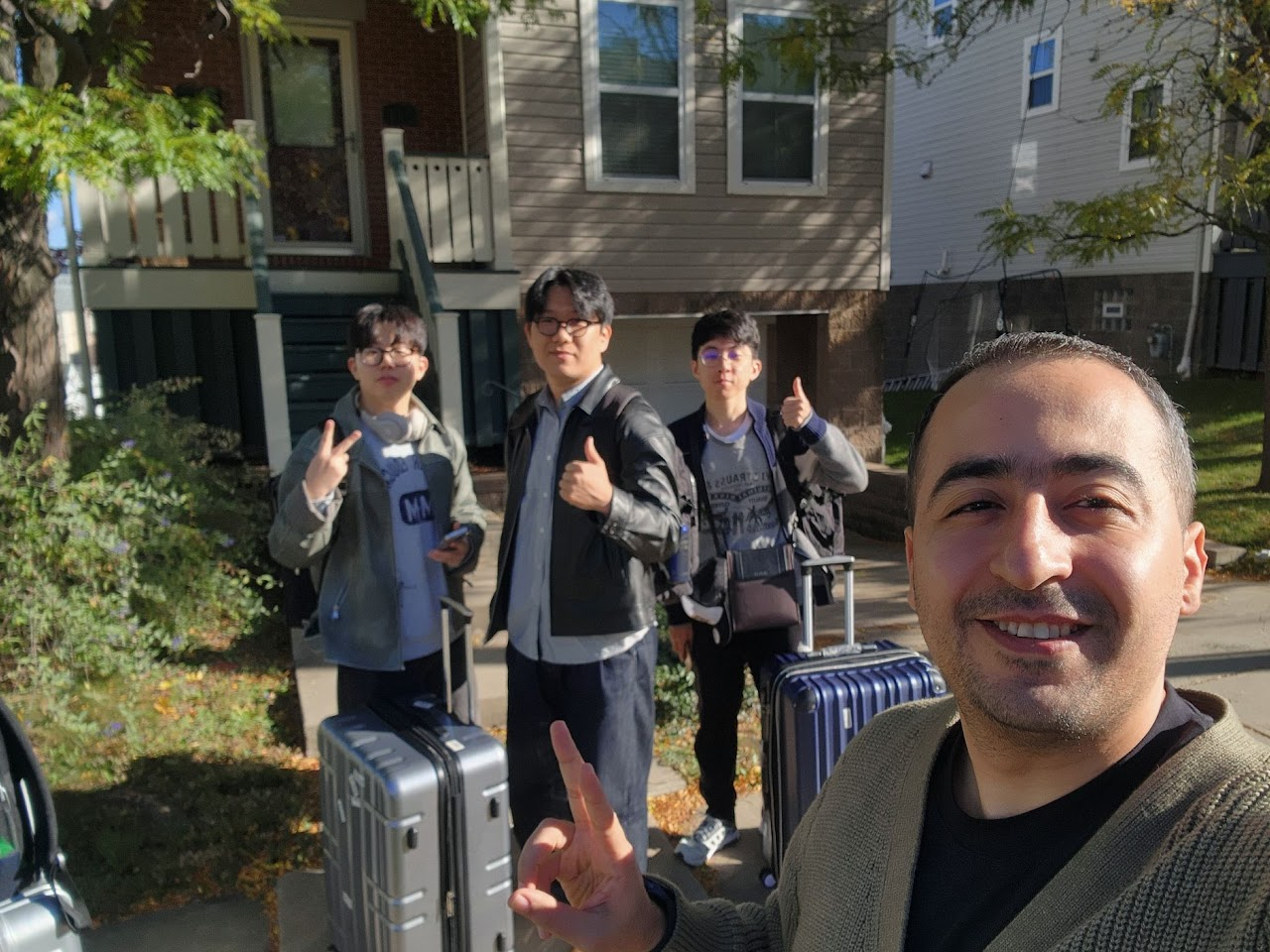 Outdoor group selfie with luggage during the UIST 2024 conference trip.