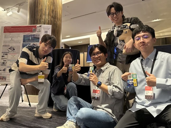Group photo at a demonstration booth at UIST 2025.