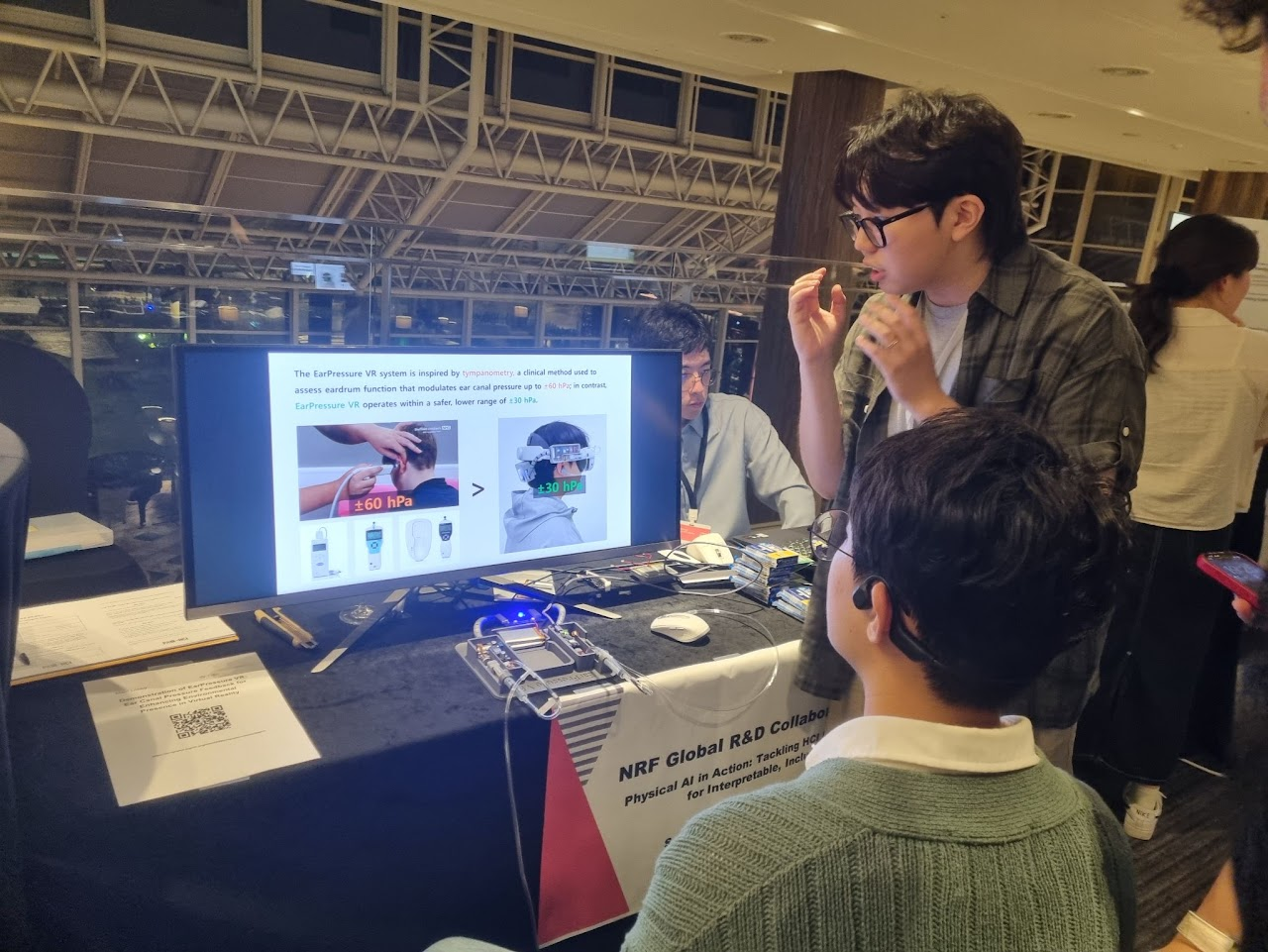 Explaining the EarPressure VR demonstration during the UIST 2025 conference trip.